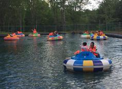 Young people floating down river in inner tubes