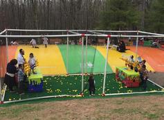 A group of people standing around on the grass.