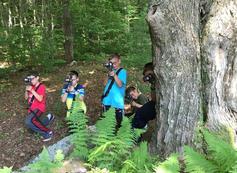 A group of people standing around a tree