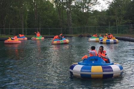 A group of people in water on floats.