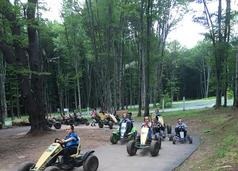 People sitting in the quad and driving race on driveway