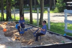 Two young childrens playing with seesaw