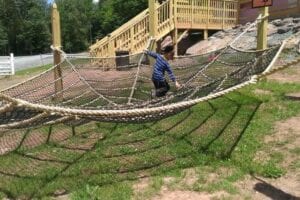 A boy playing on a giant net