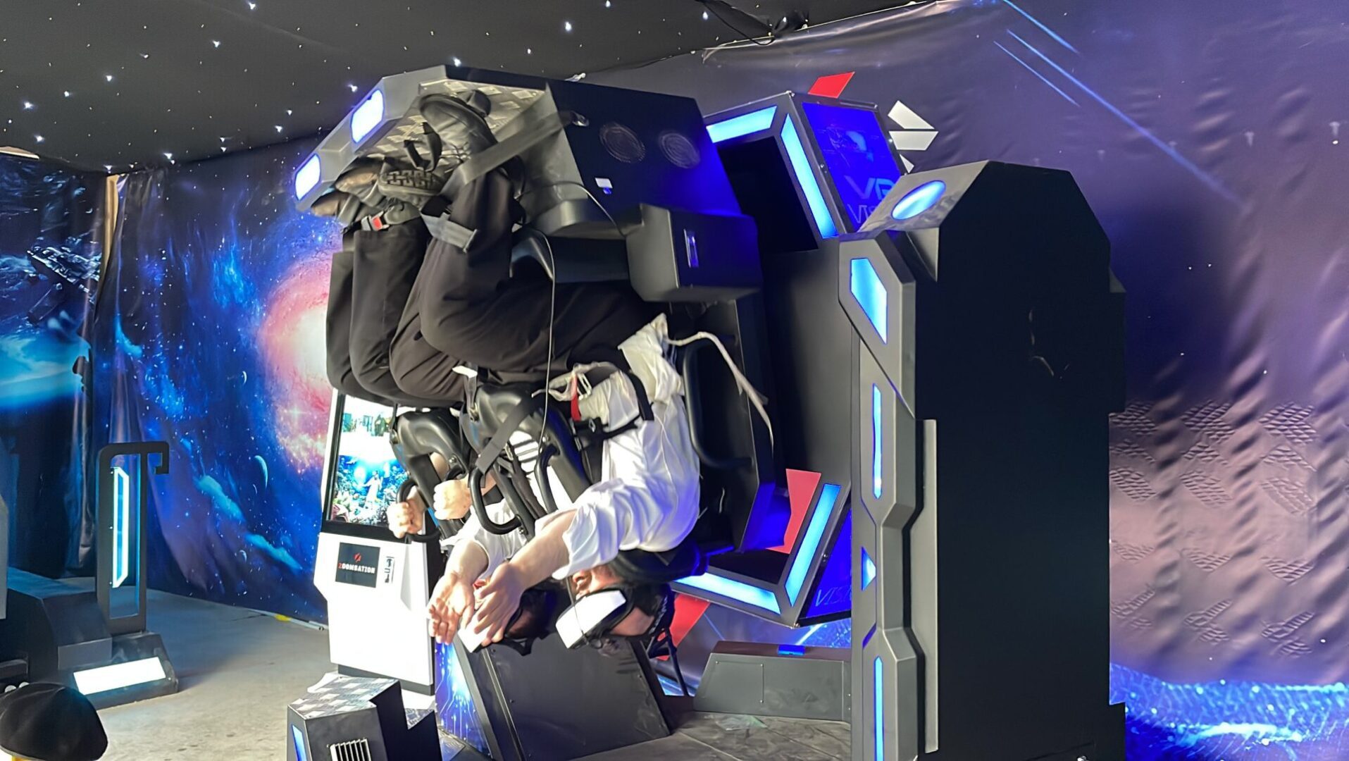 A man sitting in front of a tv with headphones on.